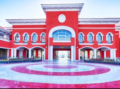 a large red building with a round courtyard at Chalets in Porto Sharm - Families Only AN in Sharm El Sheikh
