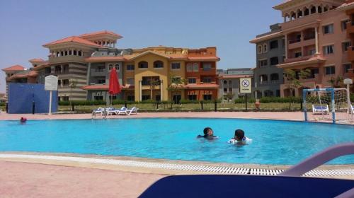 two people in a swimming pool in a hotel at Chalets in Porto Sharm - Families Only AN in Sharm El Sheikh