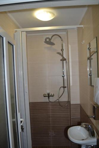 a bathroom with a shower and a sink at У Гуцула in Mukacheve