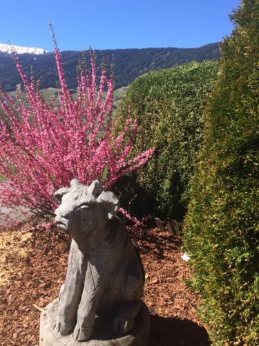 a statue of a sheep with pink flowers on its back at apart.pitztal in Arzl im Pitztal