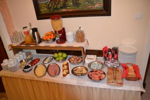a table with many different types of food on it at Anixis Hotel in Loutra Ipatis