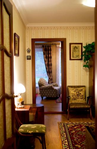 a living room with a couch and a chair and a table at Domik v lesy in Lyutezh