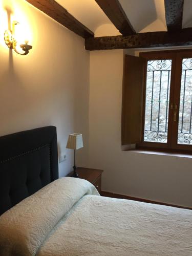 a bedroom with a bed and a window at Casa Rural de Jaime in Medinaceli