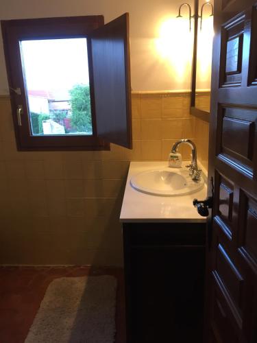 a bathroom with a sink and a window at Casa Rural de Jaime in Medinaceli