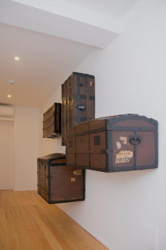 a pile of suitcases stacked on top of a wall at Quinta Nossa Senhora do Cabo in Lagoa