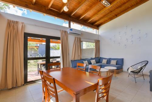 a living room with a table and a blue couch at Casas Acrux in Nono