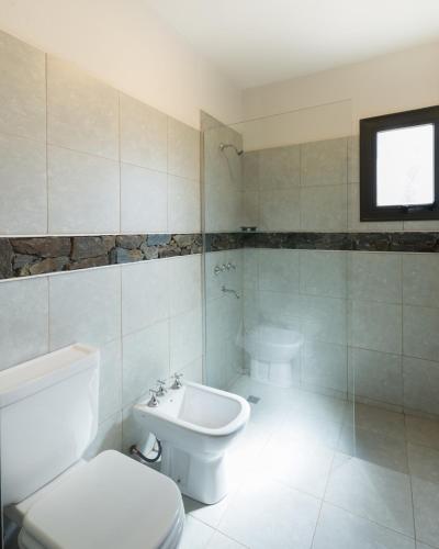 a bathroom with a toilet and a sink at Casas Acrux in Nono