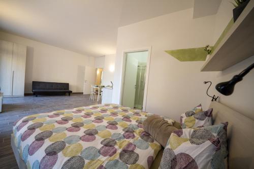 a bedroom with a bed with a colorful blanket at Apartments Fewo in Bolzano