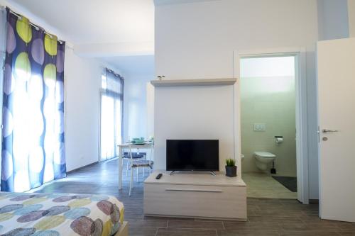 a bedroom with a bed and a tv on a dresser at Apartments Fewo in Bolzano