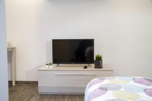 a living room with a tv on a dresser at Apartments Fewo in Bolzano