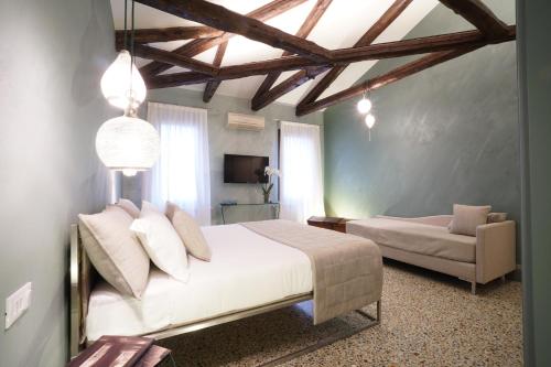 a bedroom with a white bed and a couch at P 1779 in Venice