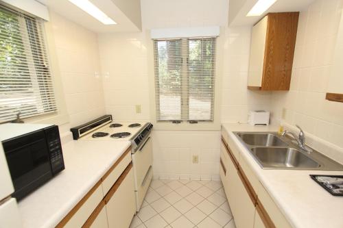 a white kitchen with a sink and a stove at Kentucky Dam Village State Resort Park in Gilbertsville