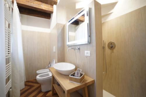 a bathroom with a sink and a toilet and a window at P 1779 in Venice