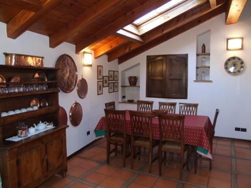 a kitchen and dining room with a table and chairs at Le Rocher in Châtillon