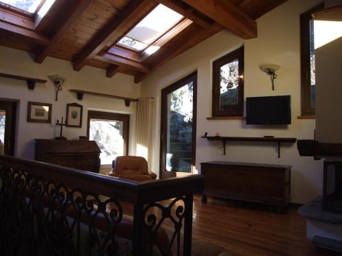 a living room with a skylight and a tv at Le Rocher in Châtillon