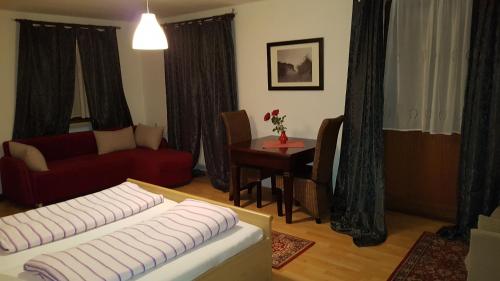 a living room with a couch and a table at Pension-Puttlachtal in Pottenstein