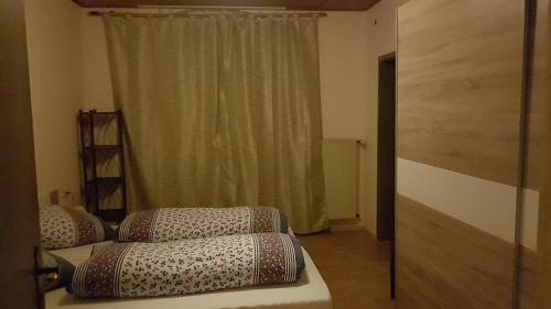 a living room with a couch and a window at Pension-Puttlachtal in Pottenstein
