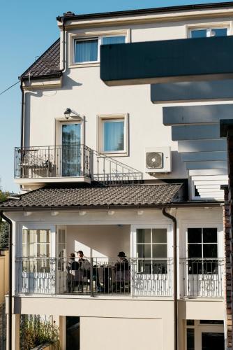 people sitting on the balcony of a building at Sundial Boutique Hotel in Zagreb