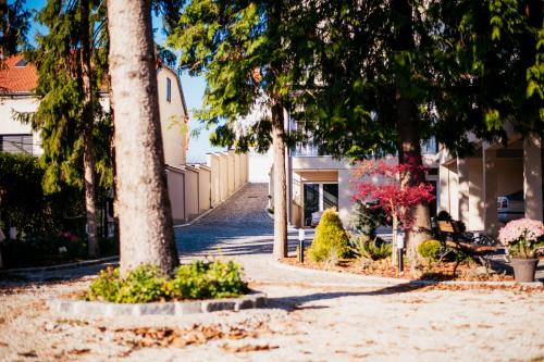 a walkway with trees and benches and a building at Sundial Boutique Hotel in Zagreb