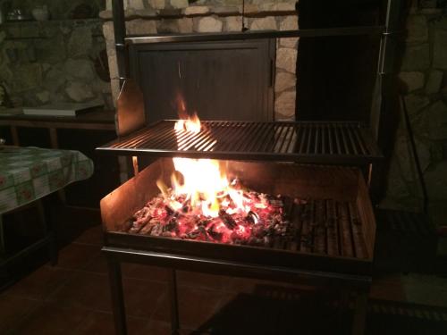 a grill with a fire inside of it at Residence Agape in Cefalù