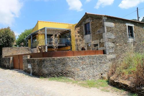 a house with a brick wall next to a street at Casa de ferias em Caminha - Minho - in Caminha