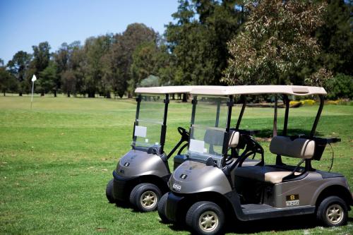 a golf cart parked in a field of grass at Howlong Golf Resort in Howlong
