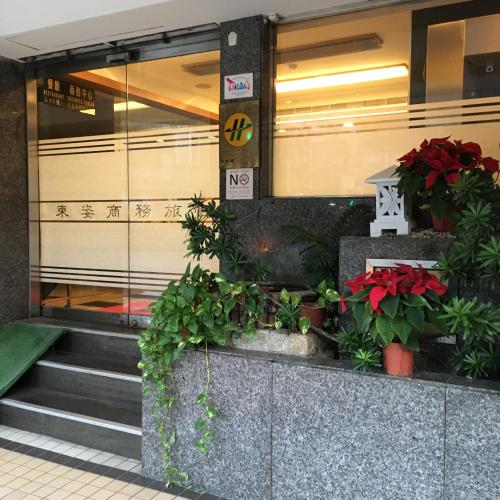 a building with some plants in front of it at Eastern Beauty Hotel in Taipei