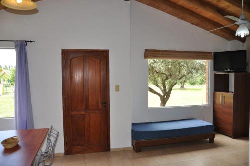 a living room with a door and a window at Cabañas Los Viñedos in San Rafael