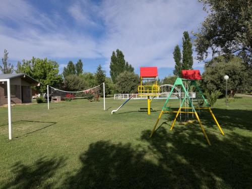 a playground with colorful equipment in a park at Cabañas Los Viñedos in San Rafael