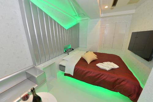 a bedroom with a bed with lights on it at Terrace M Yokota Bace ( Adult Only ) in Hakonegasaki