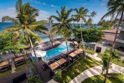 an aerial view of a resort with a pool and palm trees at Katamaran Hotel & Resort in Senggigi 