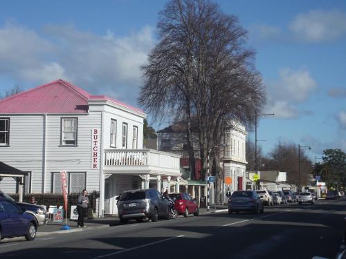 a street with cars parked on the side of the road at Greytown Campground in Greytown