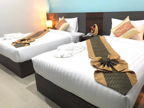 two beds in a hotel room with bows on them at Aonang Sea Valley Resort in Ao Nang Beach