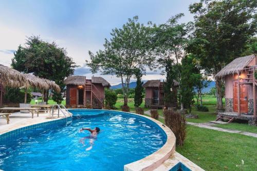 a man in a swimming pool at a resort at The Countryside Pai in Pai