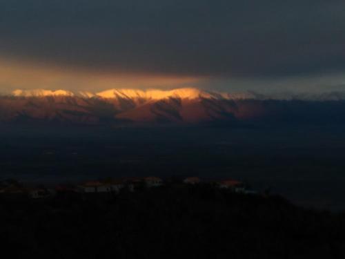 a view of a mountain range at sunset at Guest House Aisi in Sighnaghi