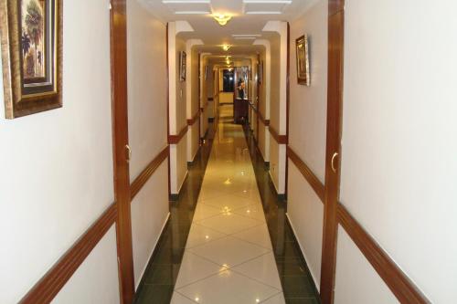 a corridor in a hotel with a long hallway at Boma Inn Nairobi in Nairobi