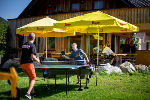 two men playing ping pong on a ping pong table at Da Bräuhauser in Stadl an der Mur