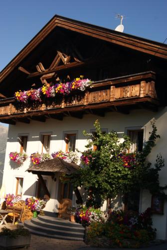 a building with flower boxes and balconies on it at Bichlhof in Niederthai