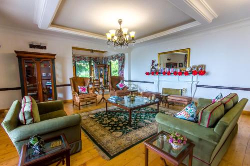 a living room with two couches and a table at Mahasu House in Shimla