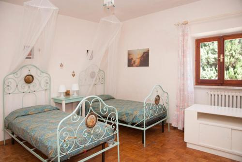 a bedroom with two beds and a window at Villa degli Scoiattoli in SantʼElpidio a Mare