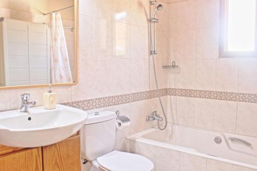 a bathroom with a sink and a toilet and a shower at Villa Majestic in Ayia Marina
