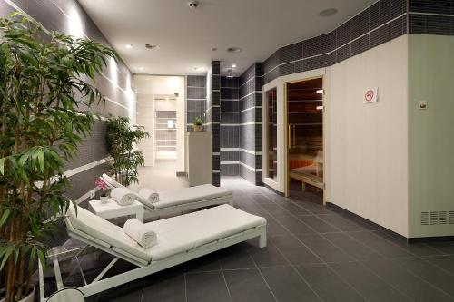 a hospital room with two beds and plants at Eurostars Book Hotel in Munich