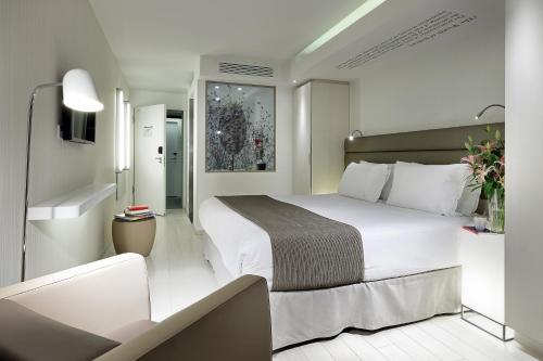 a hotel room with a large white bed in it at Eurostars Book Hotel in Munich