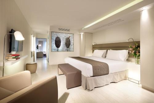 a hotel room with a bed and a television at Eurostars Book Hotel in Munich