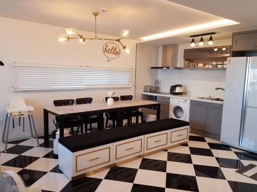 a kitchen with a black and white checkered floor at HANI Haus in Jeju