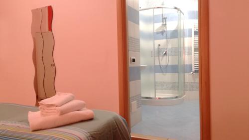 a room with a shower and towels on a bed at Bovio Modern Suite in Naples