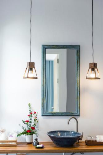 a bathroom with a sink and a mirror on the wall at Krabi Home Resort in Tab Kaek Beach