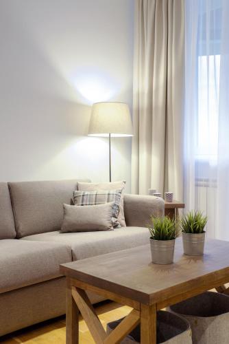 a living room with a couch and a coffee table at Brzeće Center Apartments in Kopaonik