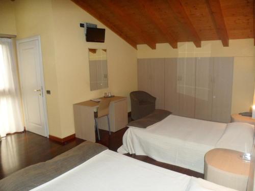 Postel nebo postele na pokoji v ubytování Hotel Fontana Santa
