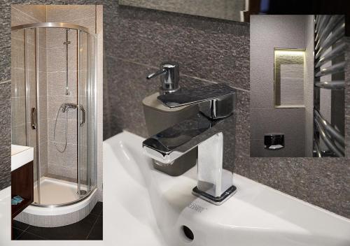 a bathroom with a sink and a shower at Aparthotel Łódź 55 Piotrkowska in Łódź
